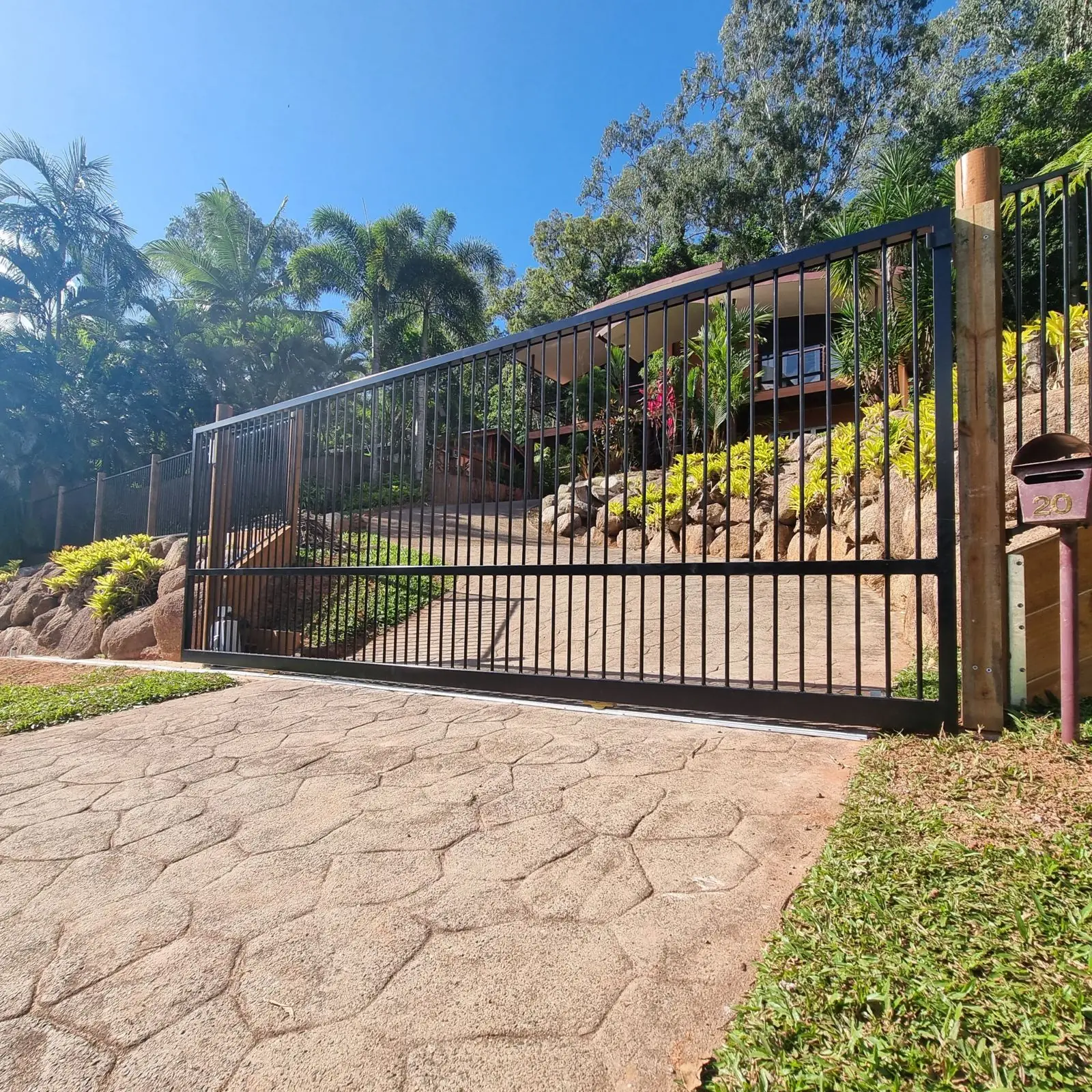Black steel motorised sliding driveway gate
