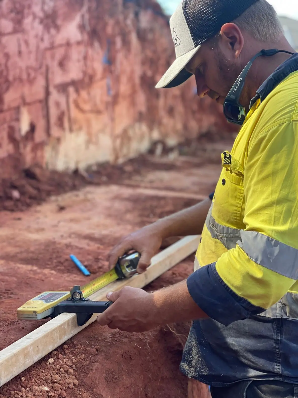 QuickDig team member checking levels with a laser receiver