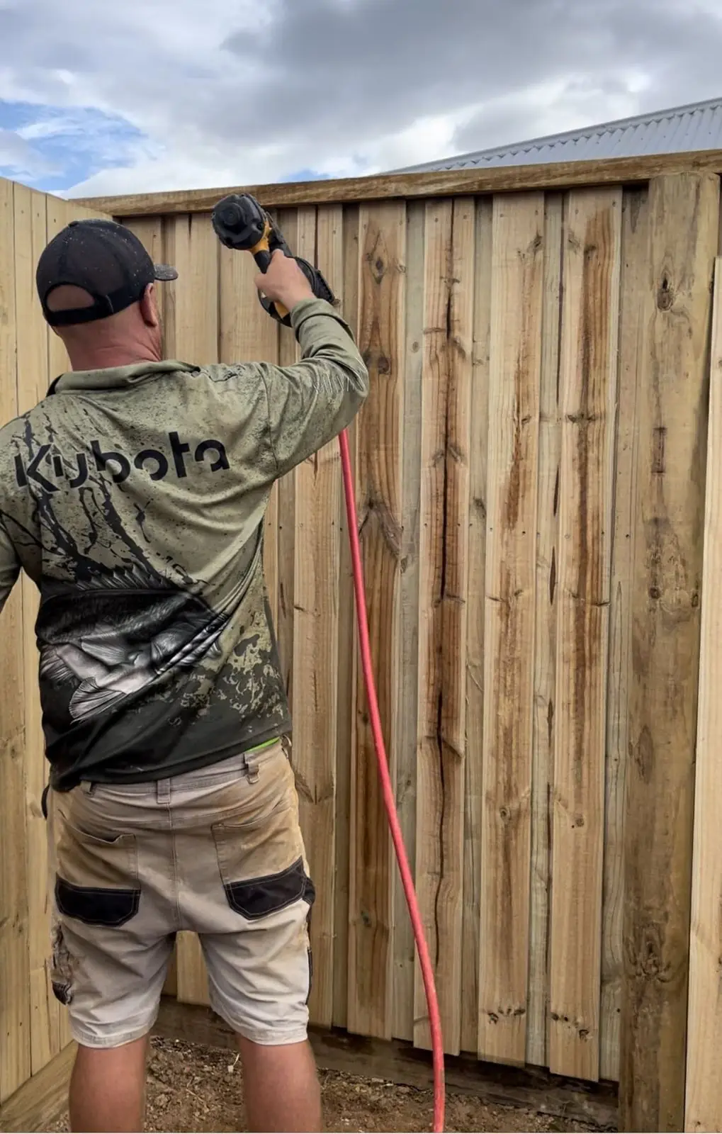 QuickDig team nailing a paling fence