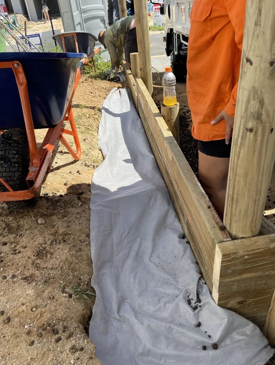 Geofabric laid along a new treated pine sleeper wall ready for drainage gravel