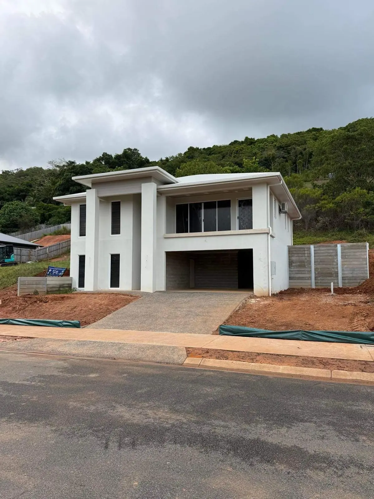 New home with concrete sleeper retaining walls and finished site