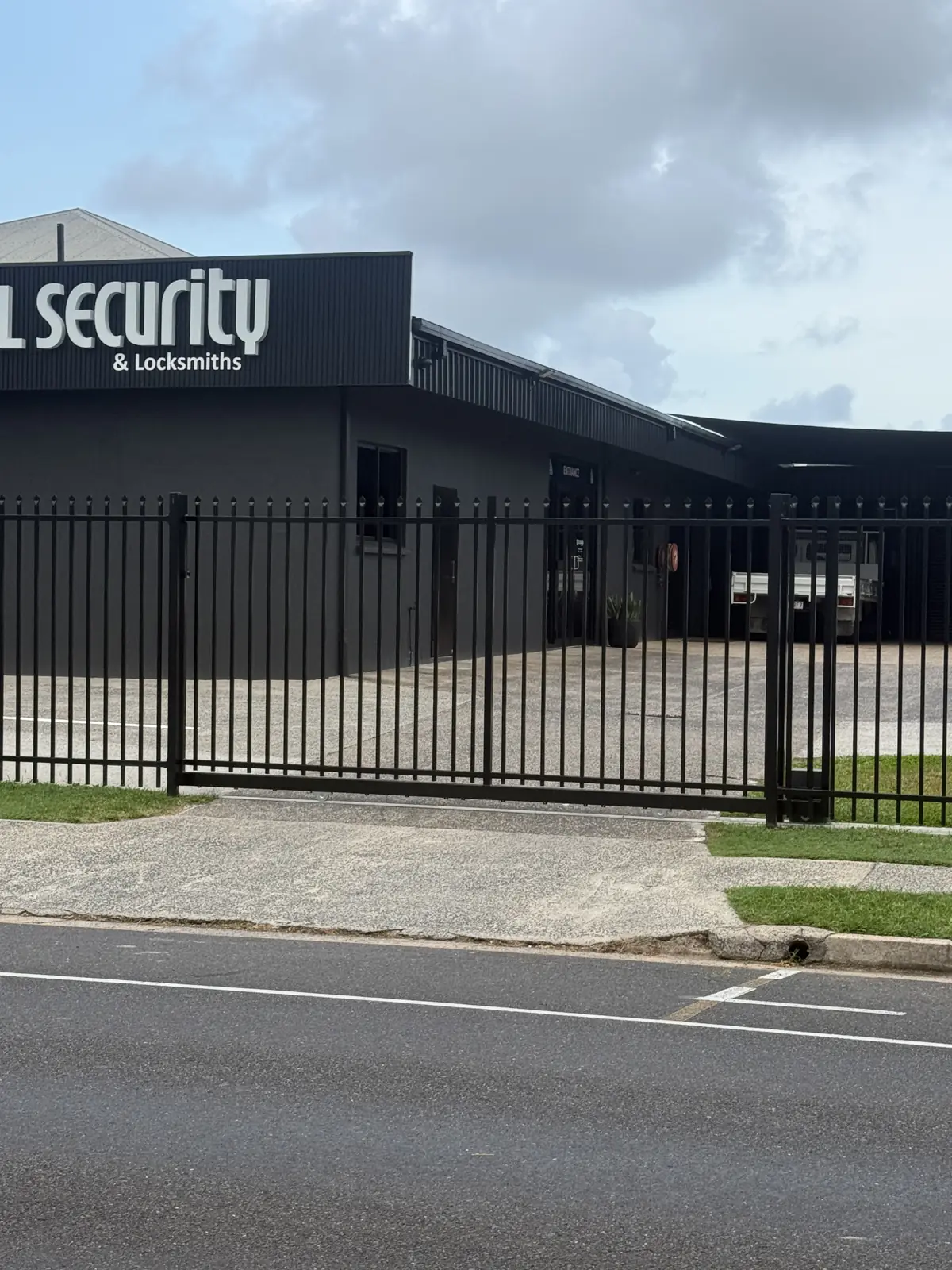 Black press-top aluminium sliding gate at a commercial site